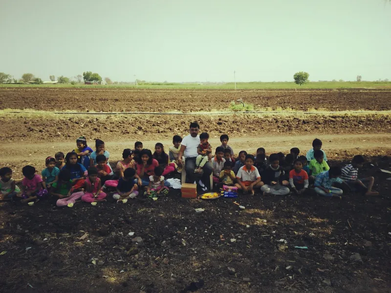 Children of SaiAshraya gathered for an outdoor meal